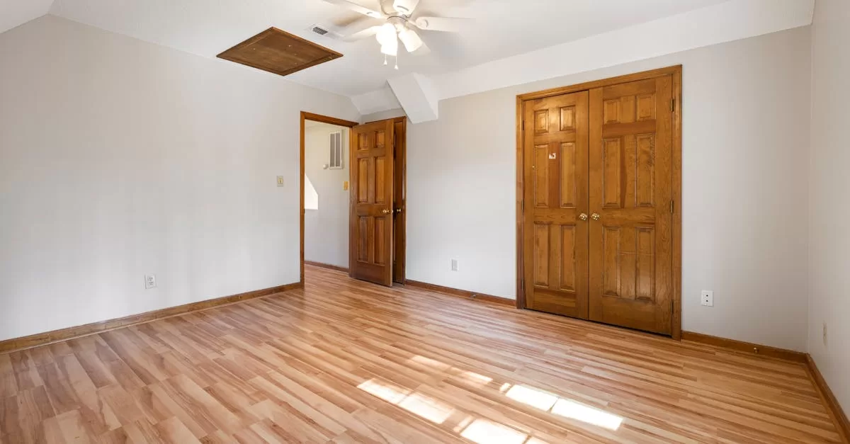 Empty Room with Wooden Flooring and Doors