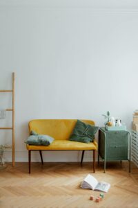 Stylish living room showcasing a vibrant sofa, soft textiles, and minimalist decor.