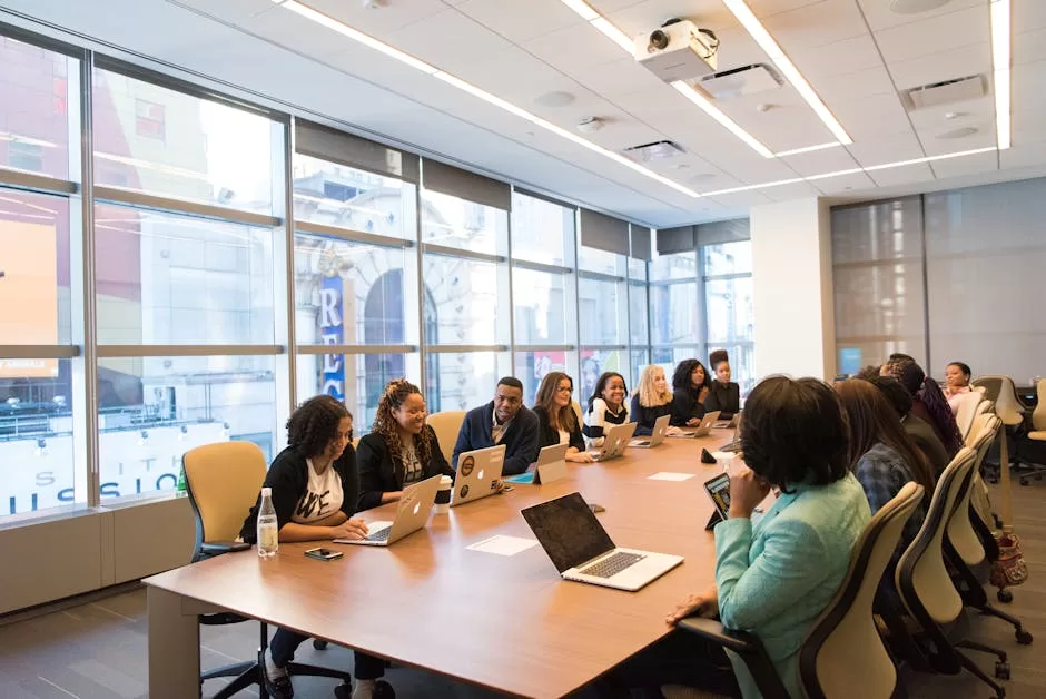 A diverse team of business professionals collaborating in a modern meeting room.