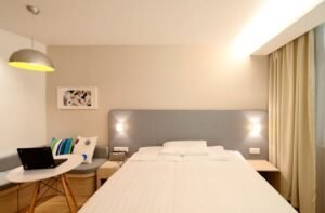 Contemporary hotel room with minimalist interior design and cozy lighting.