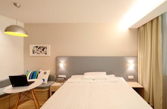 Contemporary hotel room with minimalist interior design and cozy lighting.