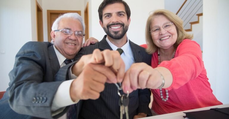 Smiling elderly couple receiving house keys from realtor indoors.